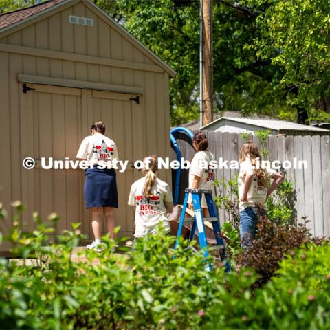 Members of Tri Delta, Sophie Helm, Alyssa Dunlap, Rachel Nelson, and Kate Freeman, go to a homeowner’s shed to put away tools that were provided to them during the Big Event. May 4, 2024. Photo by Kirk Rangel for University Communication.